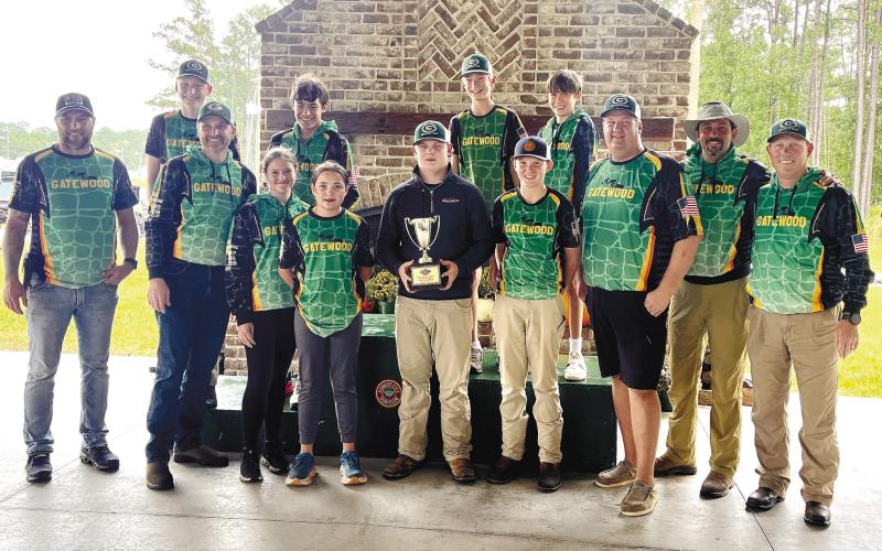 The coaches and student-athletes of Gatewood’s middle school shotgun team pose with the winning hardware Oct. 13, after securing their fourth-consecutive state championship at the GIAA Middle School Shotgun Invitational in Savannah. CONTRIBUTED