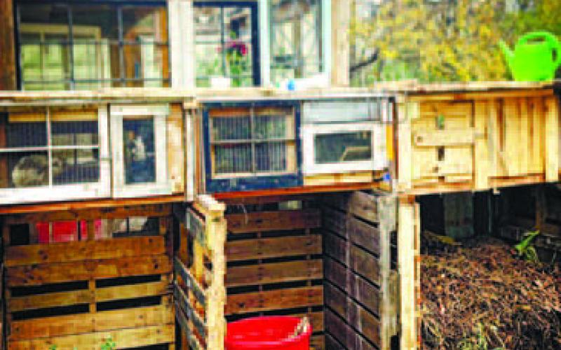 Three bin compost pile setup with rabbit hutches on top. CONTRIBUTED