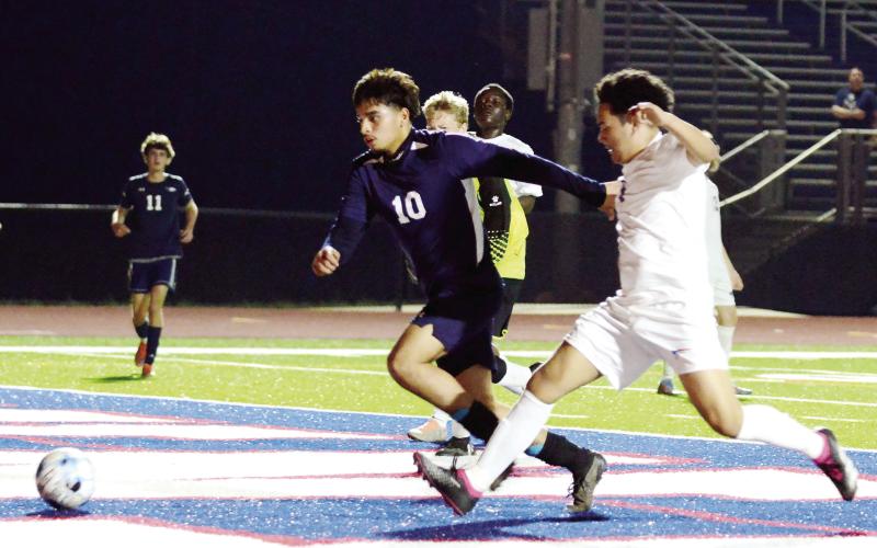 Putnam County leading-scorer Emmanuel Meraz (10) races to score a goal past a defender last Thursday in a win over Westside-Augusta. IAN TOCHER/Staff