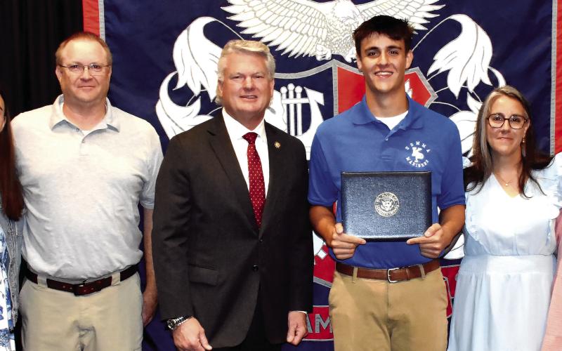 District 10 Congressman Mike Collins (center) with Putnam County High School senior Tanner Lukens and his family last Friday, during Lukens’ signing ceremony to begin attending the U.S. Merchant Marine Academy this fall. IAN TOCHER/Staff