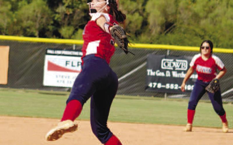 Amelia Morris gets things started for the Lady Eagles with a solid hit. Senior Sara Hulsey starts off in the pitcher’s circle against Washington County.