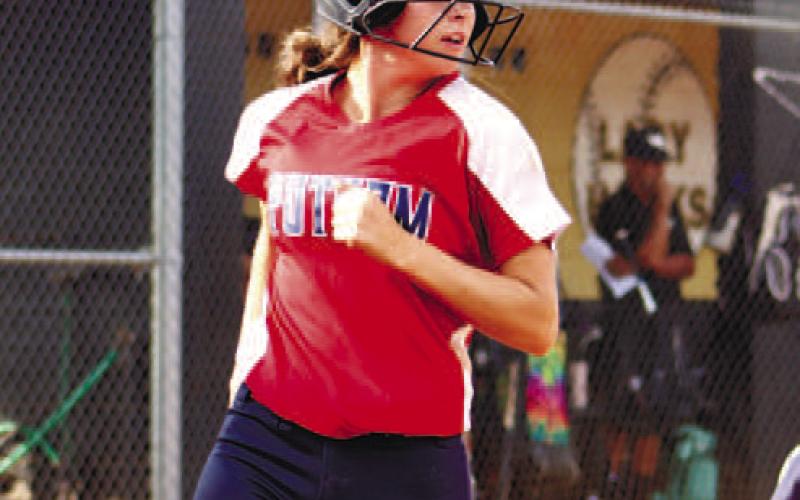 Sara Hulsey crosses home plate for a score.