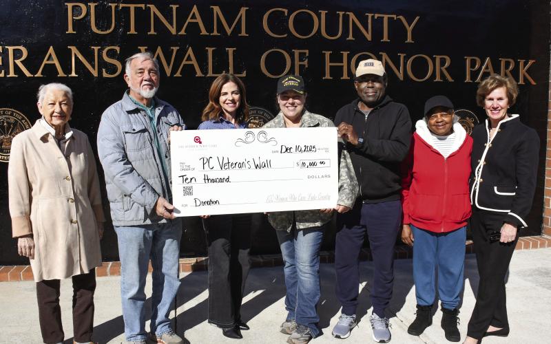 L-R: Talethia and Randy McMichael joined 100 Women Who Care Lake Country Director Rebecca Prance and Veterans Wall of Honor Park administrator Nikki Barker, with Rev. Sidney Jackson, his wife, Lula, and 100WWCLC member Nancy Marshall, as the charitable organization made a $10K donation to support the downtown Eatonton park. IAN TOCHER/Staff