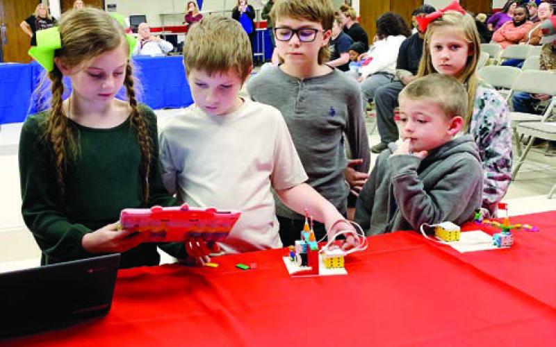 Second graders code the entry way to the amusement park on the iPad. The coding was demonstrated on a screen to the audience on their left. BAILEY MCCULLY/Staff