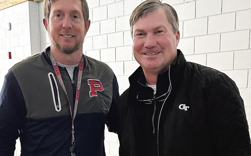 Putnam County head football coach Joel Harvin (left) is joined by Georgia Tech assistant coach Brian Bohannon in a recent visit to the school. CONTRIBUTED