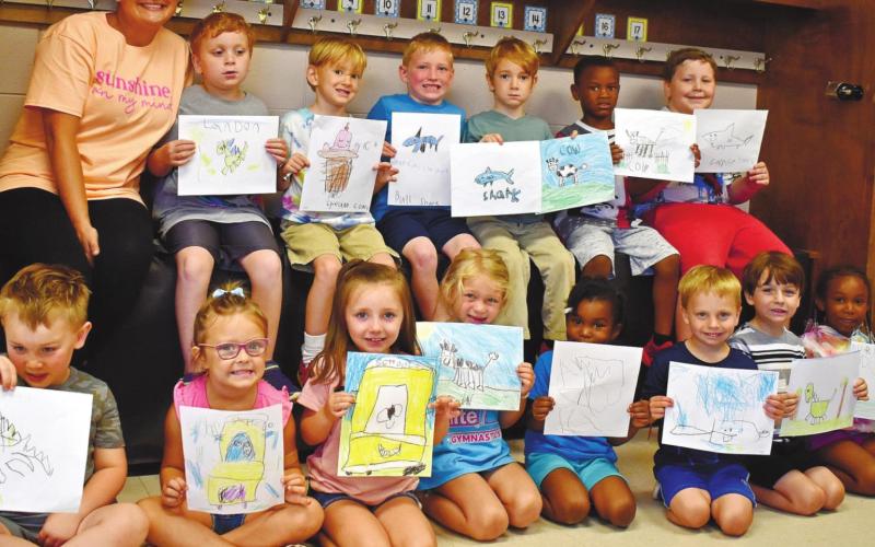 The campers showing off their drawings include, back row, from left, teacher Anna Watkins, Landon Hubert, Jed Esau, Blake Roberts, Gus Esau, Robert Parker, Garrison Giddens. Front row, from left, Woodson Karlin, Sadie Reid, Ava Archer, Annie Cummings, Athena Hall, Collin Spires, Trevor, Aubrey Roberts.