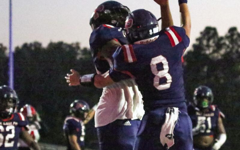 Putnam County quarterback Branan Griffin (8) celebrates with a teammate after scoring a touchdown in Friday’s 45-37 region win over McNair. LANCE McCURLEY/Staff