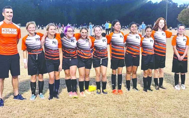 Coach David Wright (far left) with his 11-13 girls’ soccer team. CONTRIBUTED