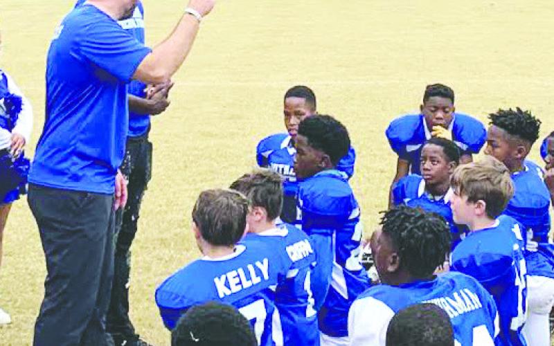 Coach Michael Griffin gives his team a pep talk. CONTRIBUTED