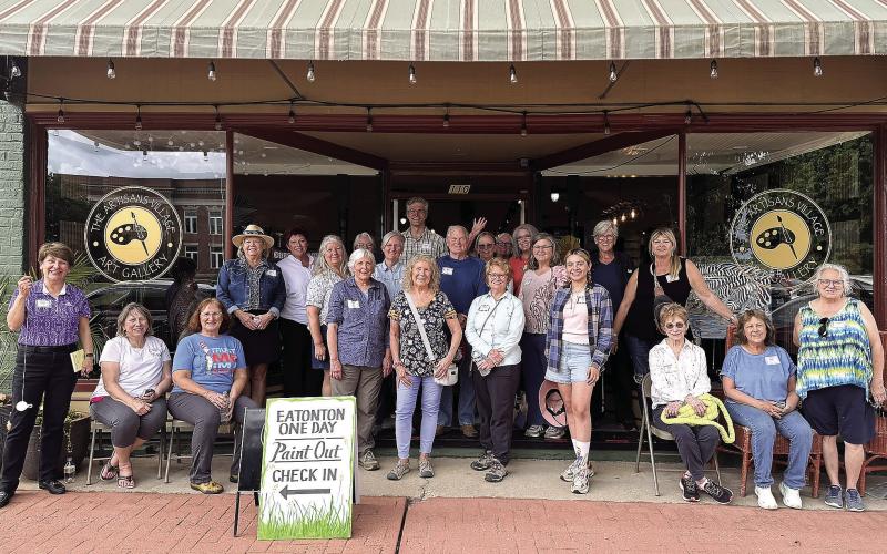 Attendees of the 8th annual Paint Out pose in front of the Artisan Village Guild. CONTRIBUTED