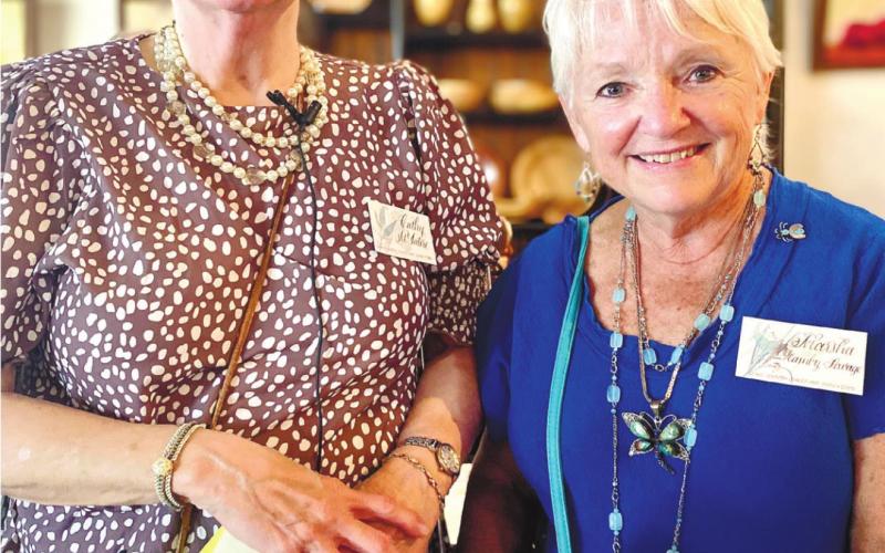 (Left) Cathy McIntire, 2022 Lake Country Juried Art Show Chair hands out the first place award to Marsha Hamby Savage for her artwork, “Purple Mountain Majesty.” CONTRIBUTED