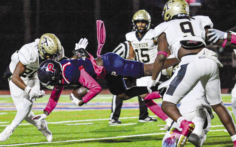 Putnam County’s Kaleb Crawford dives ahead for extra yardage. CHARLES JORDAN/Staff