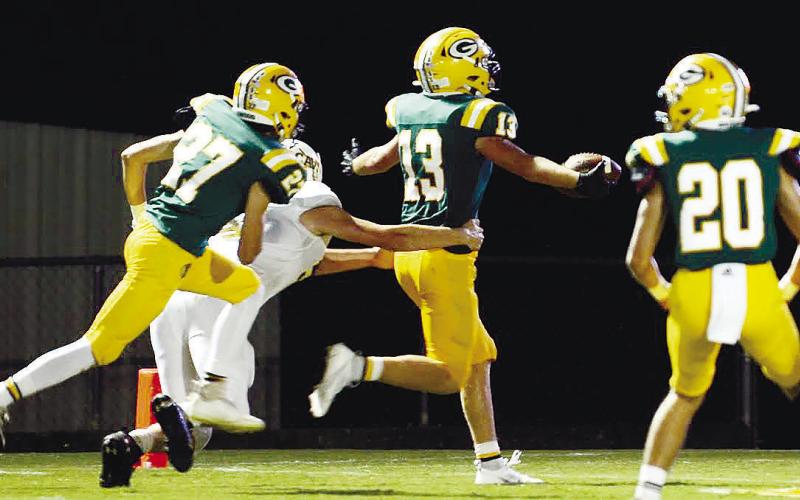 Gatewood players Bodie Curry (27), Luke McNeill (13) and Landon Moreno (20) celebrate a touchdown in a game held earlier this season in Eatonton. This Friday, the Gators face their biggest test of the season so far, as so-far undefeated league leader Edmund Burke Academy comes to town. IAN TOCHER/File photo
