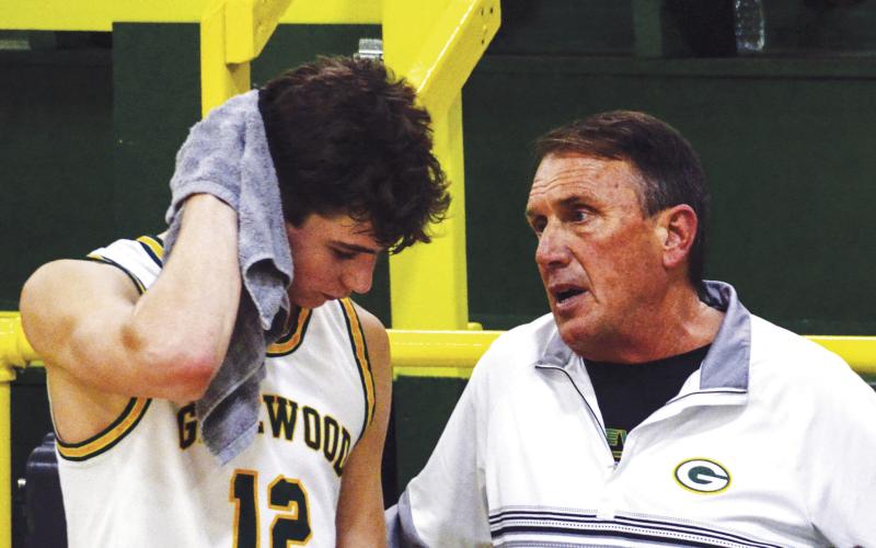 Gatewood head coach Don Keiser talks with leading scorer Matt Allen during a break last Friday night during a game against Mount de Sales Academy out of Macon. IAN TOCHER/Staff