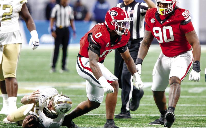 Georgia edge rusher Gabe Harris Jr. (0) celebrates after tackling Georgia Tech quarterback Haynes King for a loss. LANCE McCURLEY/Staff