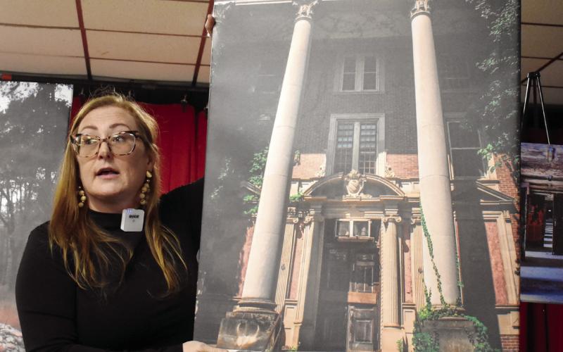 Seeking Asylum photographer Jessica Whitehead holds a picture of the Jones Building as she explains her journey with photography and Central State Hospital’s history. BAILEY MCCULLY/Staff