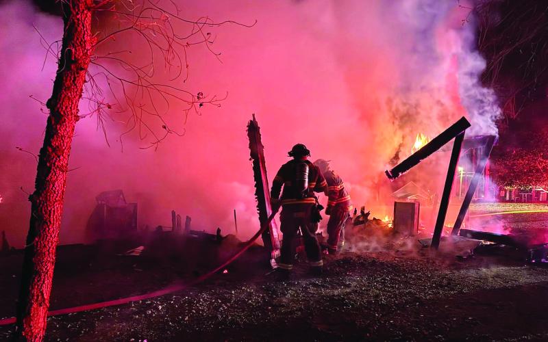 Putnam County Fire Department firefighters extinguish what was left of a fire that burned this detatched garage to the ground last week. CONTRIBUTED