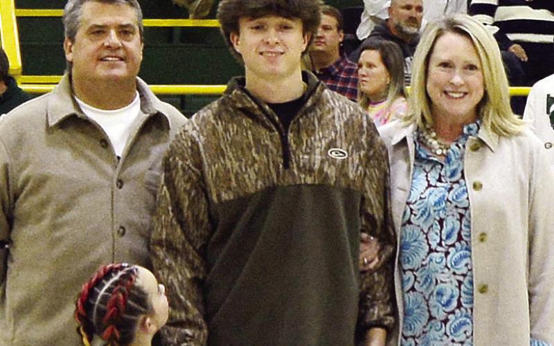 Shotgun team member Lawery Benner was escorted by his parents Leslie Anne and Michael, with K-5 buddy Willow Burrow. Lawery is a two-time, all-state competitor in shotgun as well as a state title holder. He plans to attend Emmanuel College. IAN TOCHER/Staff