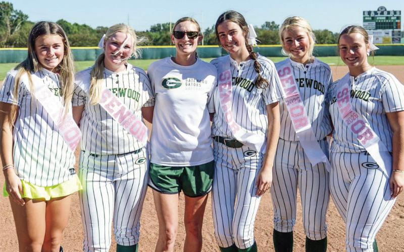 Gatewood softball coach Dena Stancil (center, green shorts) poses with her senior players this season (l-r): Natalie Sills, Lily Huskins, Riley Roberts, Ellie McMillian, and Cora Tkacik. CONTRIBUTED