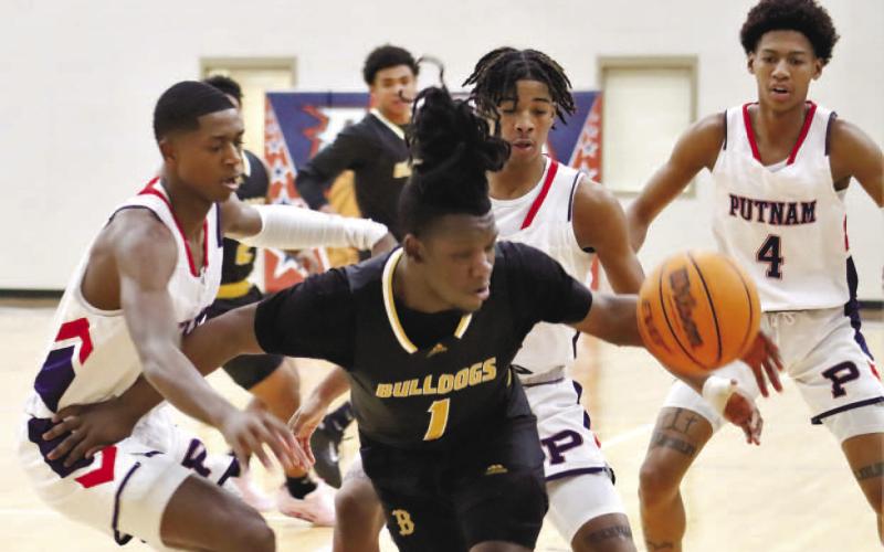 Strong defense against Zy’Quan Grant of Butler came from Putnam’s Eren Banks (left), Keyni Crawford (4) and Payton Ellison (0). ARELLA CASH/Staff