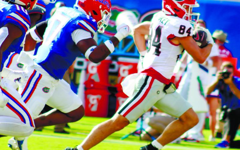 Georgia wide receiver Ladd McConkey (84) runs away from Florida defenders for a 41-yard touchdown. LANCE McCURLEY/Staff