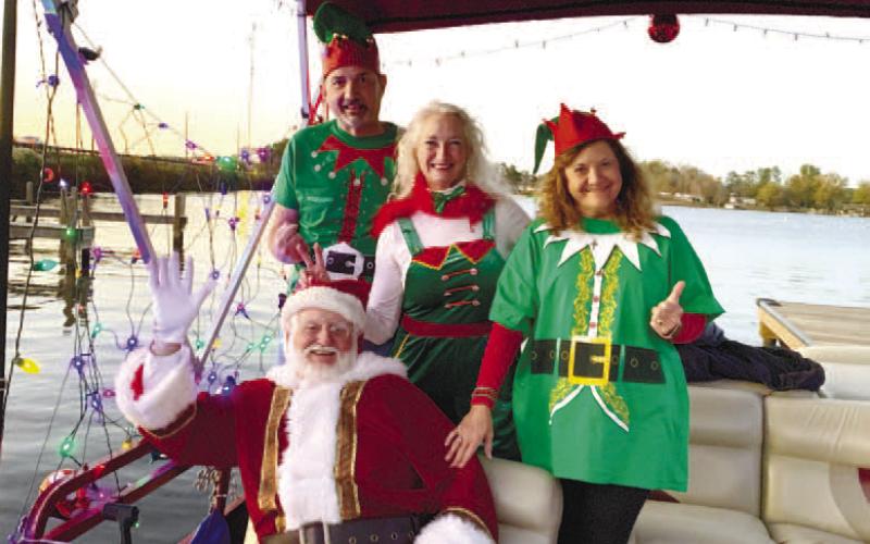 Santa and his elves pose on their cruise ship before it takes off toward Christmas Cove. BAILEY BALLARD/Staff