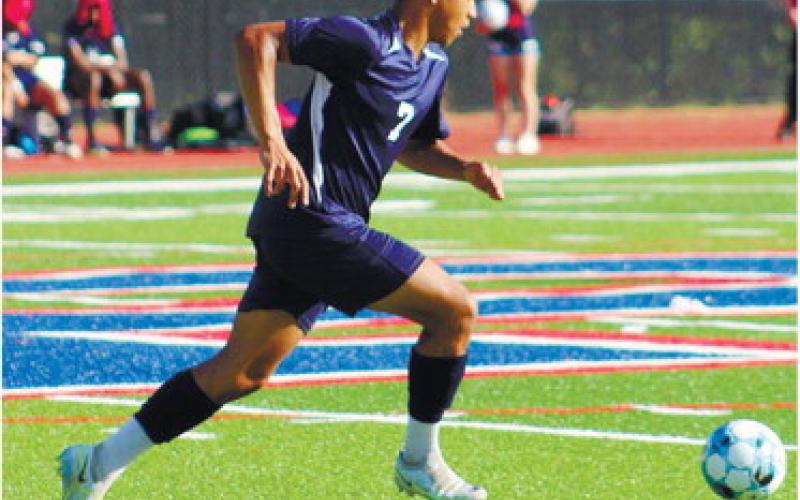 Marco Owenby (7) dribbles the ball up the pitch. ARELLA CASH/Staff