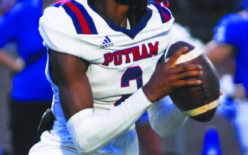 Robertson drops back to pass against Oconee County in a road game during the 2023 season. FILE PHOTO