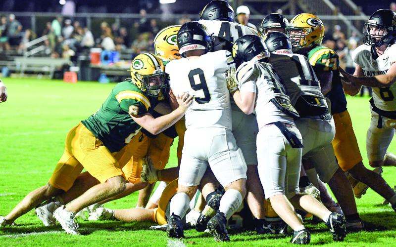 Gatewood quarterback Blake Brannen is somewhere in the middle of the crowd as he gets pushed across the goal line by teammates for the Gators’ lone score on Friday night. IAN TOCHER/Staff