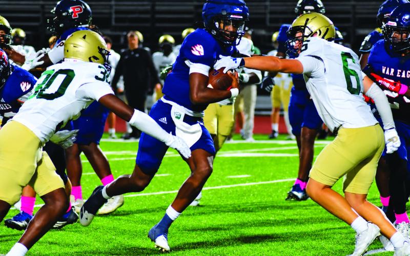 Putnam quarterback Caleb Reeves breaks through the Aquinas defensive line en route to a long touchdown run last Friday night against the Fighting Irish. BRANDON PARK/Staff