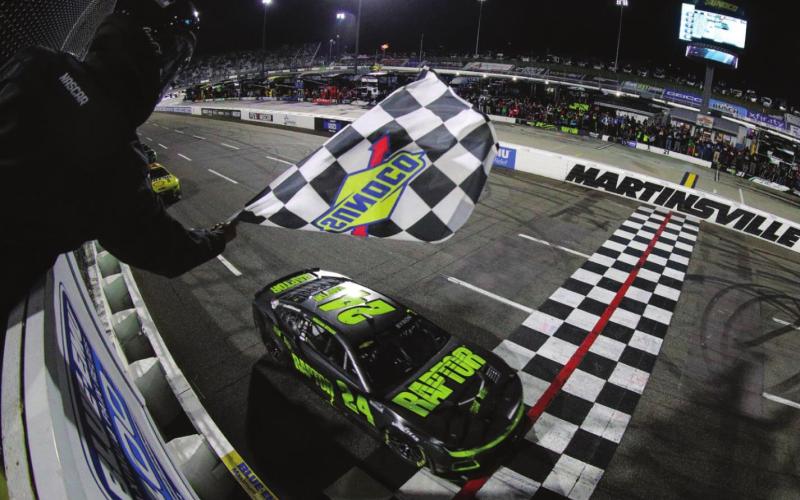 William Byron, driver of the #24 RaptorTough.com Chevrolet, takes the checkered flag to win the Cup Series Blue-Emu Maximum Pain Relief 400 at Martinsville Speedway Saturday night. (Meg Oliphant/Getty Images)