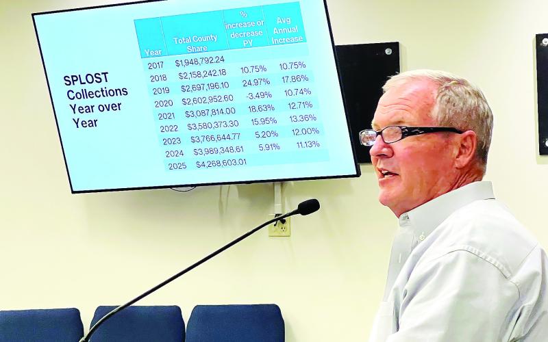 Putnam County Manager Paul Van Haute addresses local politicians on Monday, describing the history and potential of a local SPLOST. IAN TOCHER/Staff
