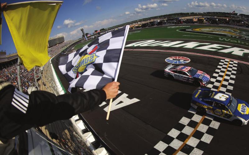 Chase Elliott, driver of the #9 NAPA Auto Parts Chevrolet, takes the checkered flag ahead of Ross Chastain, driver of the #1 Jockey Chevrolet, under caution to win the Cup Series Quaker State 400 at Atlanta Motor Speedway Sunday. (Jared C. Tilton photos/Getty Images)