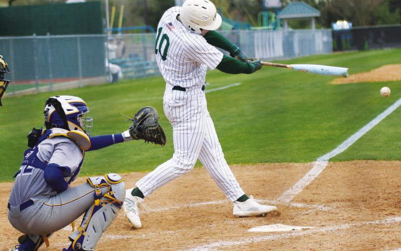 Gatewood senior Wilson Moore drives a ball out of the batter box’s during a recent game against Brentwood.
