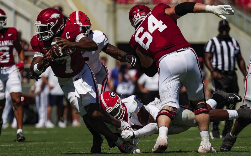 Georgia linebacker Chris Cole ankle-tackles Arkansas quarterback K.J. Jackson. The Bulldogs held the Razorbacks to 17 yards of offense on the ground. COURTESY OF UGA ATHLETICS