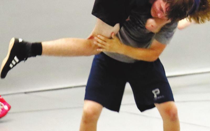 Senior Cooper Smallwood shows strength and patience during informal practice last week. ARELLA CASH/Staff