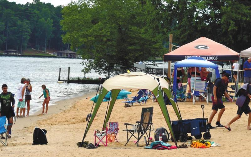 Visitors to Oconee Springs Park relax on the beach.