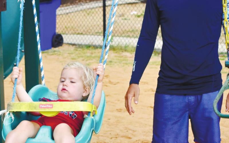 Tony Rudolph and his 23-month-old daughter Willow enjoy a swing at Oconee Springs Park.