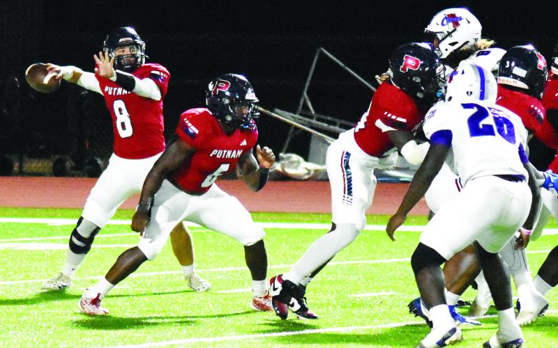 Putnam County quarterback Branan Griffin (8) gets set to fire a pass as his teammates provide him a clean pocket to throw from. T. MICHAEL STONE/Staff
