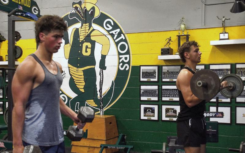 Gatewood’s Colt Jenkins (left) and Landon Moreno hit the weights in preparation for the upcoming football season. IAN TOCHER/Staff
