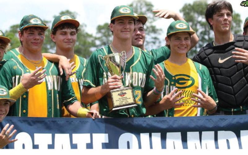 Gatewood players pose with their fourth consecutive state championship trophy last Friday in Statesboro.