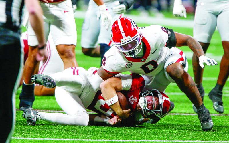 Georgia edge rusher Gabe Harris Jr. (0) celebrates after tackling Alabama quarterback Ty Simpson (15) behind the line of scrimmage. LANCE MCCURLEY/Staff