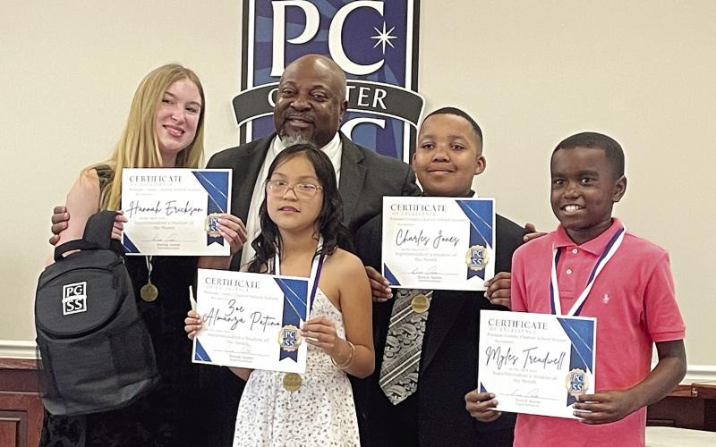 Putnam County School Superintendent Derick Austin recognizes the Student of the Month of each school, from left, Hannah Erickson (PC High School), Zoe Almanza Patino (PC Primary School), Charles Jones (PC Middle School), and Myles Treadwell (PC Elementary School). Each student was celebrated at Monday night’s board of education meeting and recognized along with their family members. LYNN HOBBS/Staff