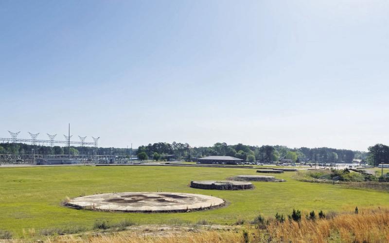 All that’s left of the once-mighty, 1,007-feet-tall smokestack that towered over Plant Branch is a circular concrete base in an open field. Built in 1978, the smokestack was dropped in a controlled demolition on Oct. 15, 2016. COURTESY GEORGIA POWER