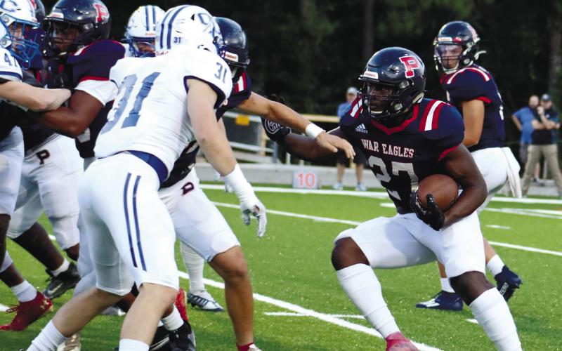 Putnam County running back Tamarion Peters (27) tries to find a hole through Oconee County’s defense. Peters also had a big impact against Jasper County. ARELLA CASH/File photo