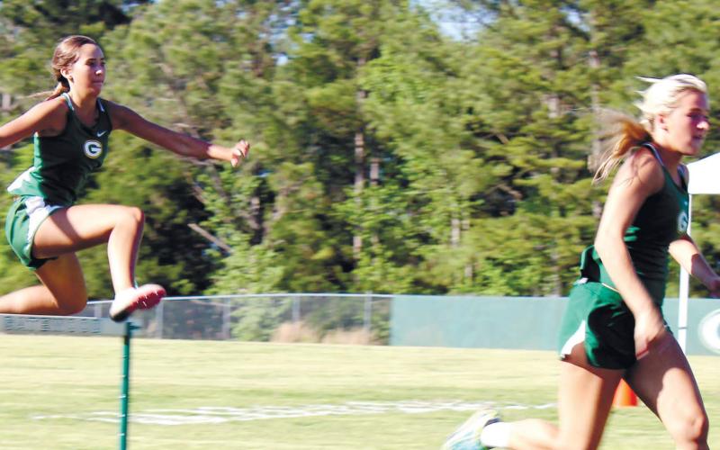 Both Anna Williamson (right) followed by London Darden (left) performed well in girls’ hurdles for the Gatewood team. TREY NORRIS/Staff