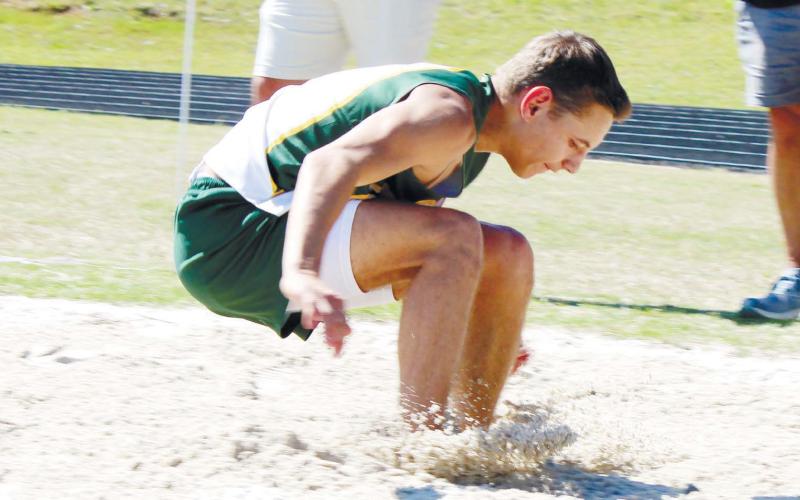 Gatewood’s Jackson Hewatt sticks the landing in triple-jump competition. TREY NORRIS/Staff