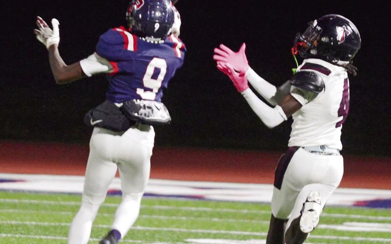 Putnam County senior Kavar Andrews (9) completed a juggling catch on this play for an interception that he ran back nearly 20 yards against Towers on Friday night. IAN TOCHER/Staff