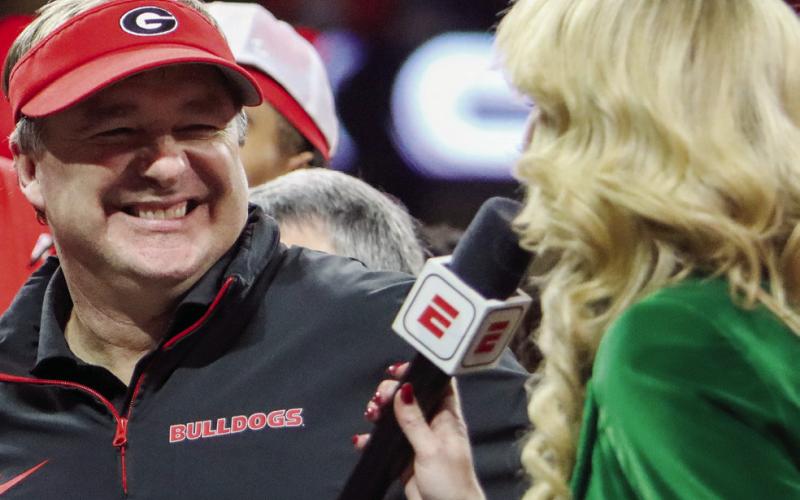 Georgia head coach Kirby Smart is all smiles during an interview with ESPN reporter Laura Rutledge after winning the SEC Championship game in Atlanta on Saturday. LANCE McCURLEY/Staff