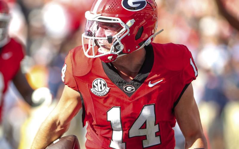 Georgia quarterback Gunner Stockton rumbles into the end zone for a rushing touchdown. LANCE McCURLEY/Staff